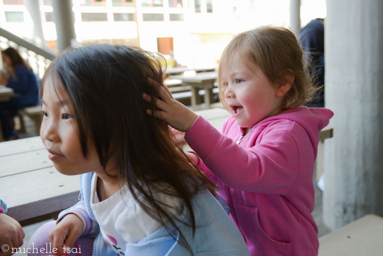 Doing up her hair while waiting for lunch.