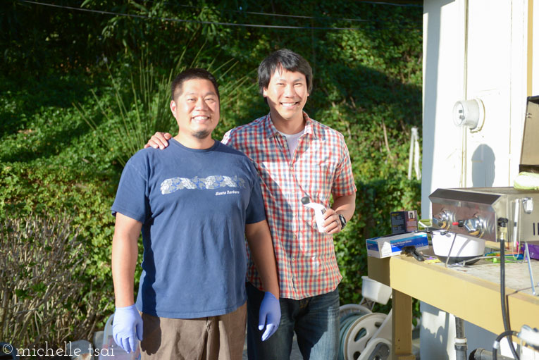 Guys grilling meat for dinner.