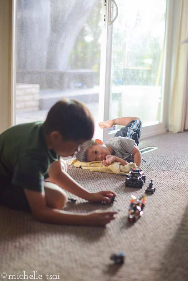 Little brother loves to watch him play, too. While plotting how to get his hands on the new toys, too.