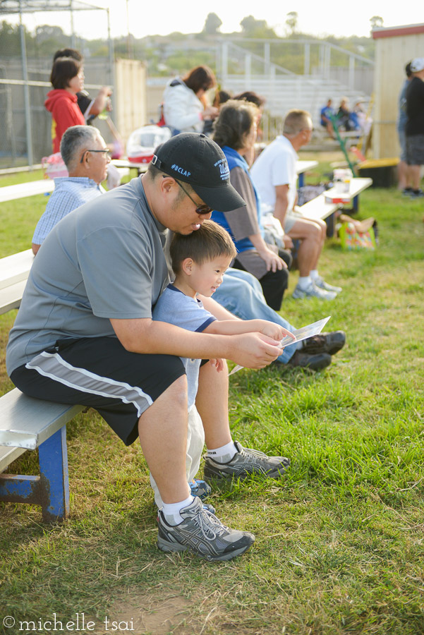 Admiring big bro's first official baseball portraits.