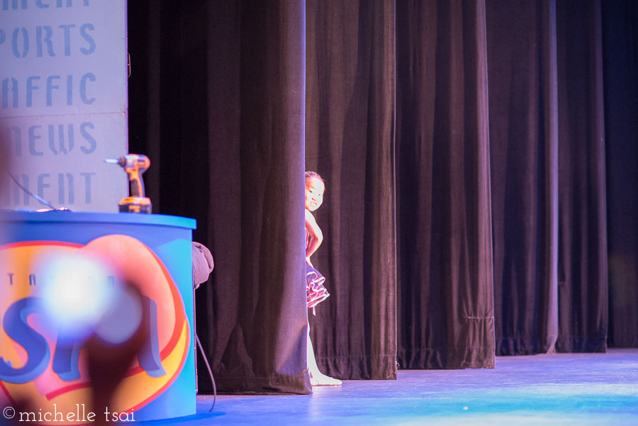 Peeking out from the curtain during the dress rehearsal.