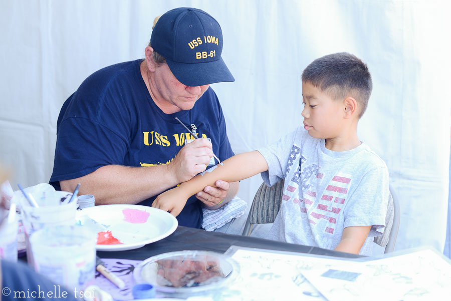 Turned out to be a good call as the ship was all decked out for the day and even included free face painting, bounce houses, live bands, and more. The kids were all over the face (er, arm, in his case) painting booth.