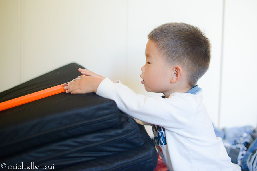 First, we rigged up a race track that went from the office down the hallway and into the boys' room. Behind Jonah would be a laundry pile.