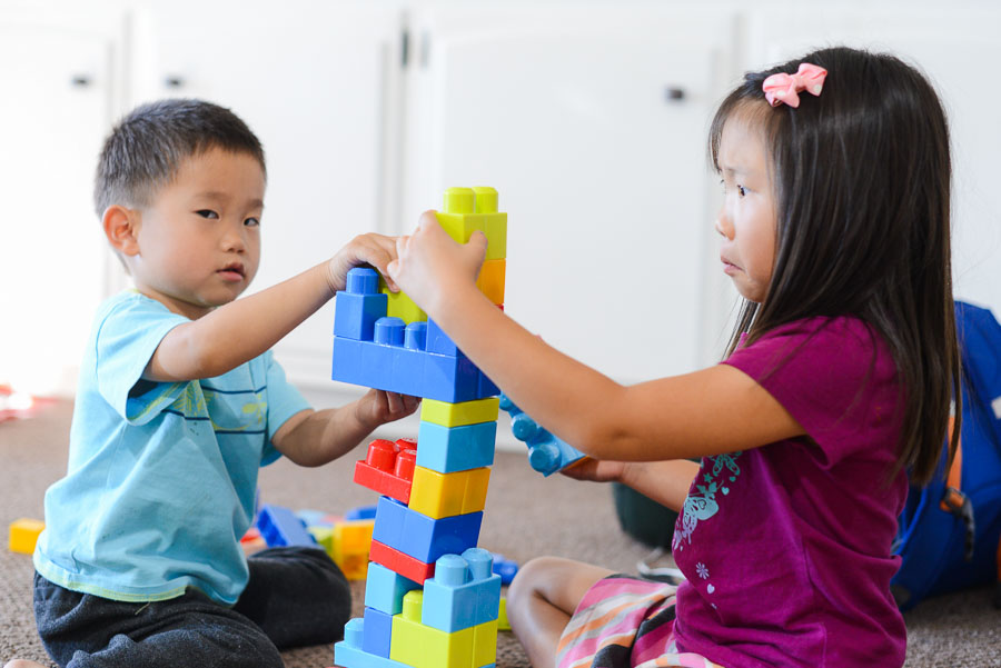 This one makes me laugh. He's eyeing me while she's trying to keep the tower from toppling over.