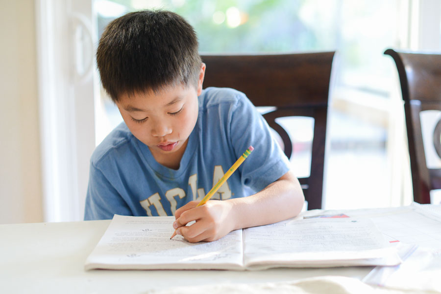 A typical afternoon in our house looks like this. Him doing homework. 