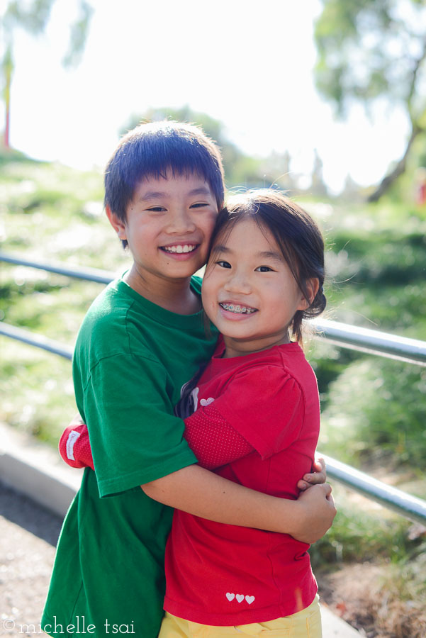 Brother and sister doing the obligatory "we are friends, we love each other, we forgive each other" hug after squabbling with each other.