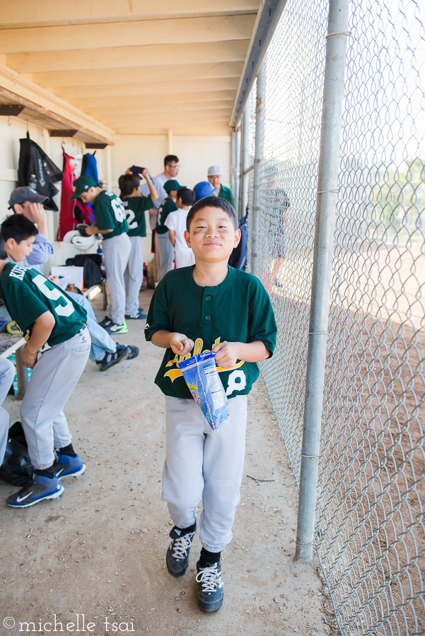 Hanging out in the dugout, chewing on sunflower seeds. His favorite part about baseball.