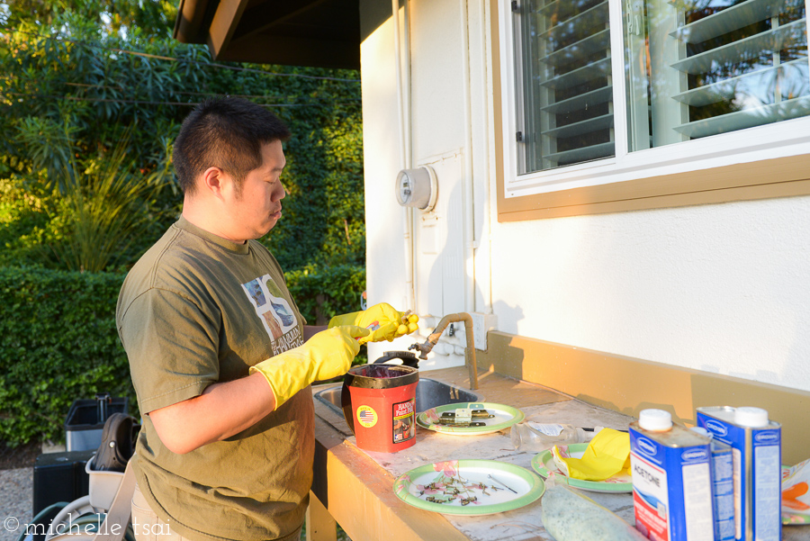 In case you were wondering what the big daddy was up to. Removing old paint from some old hinges with acetone. Because we couldn't find replacement hinges to fit our newly painted yet old-school cabinet doors so we (read: he) had to repurpose the old ones. And spray them with bronze paint. And rehang the doors. He's just cool like that.