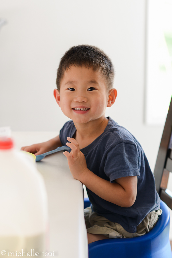 Wandering out to the living room, I found this boy sitting at the table. Never a dull moment here with a little face around every corner.