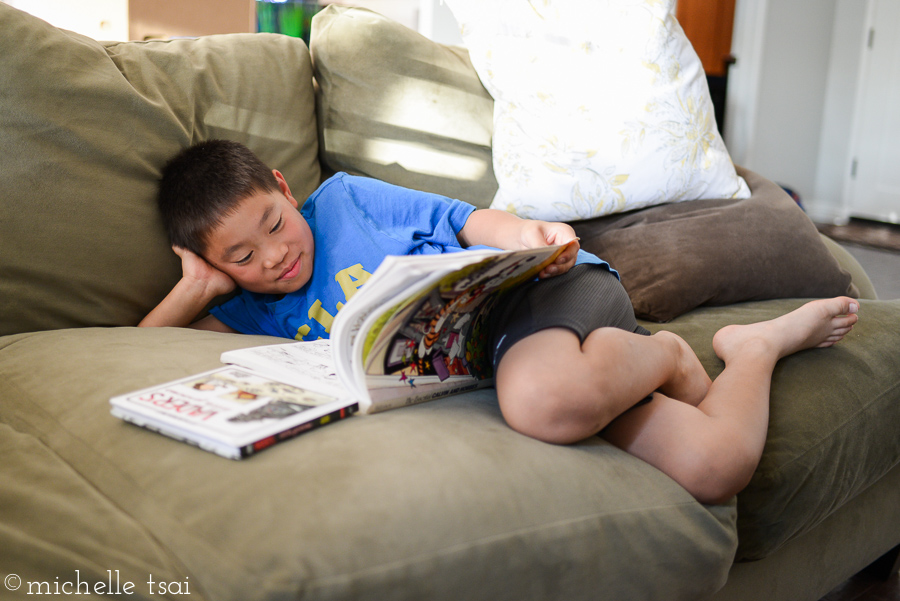 Curled up reading comic books. One of his favorite pastimes. 