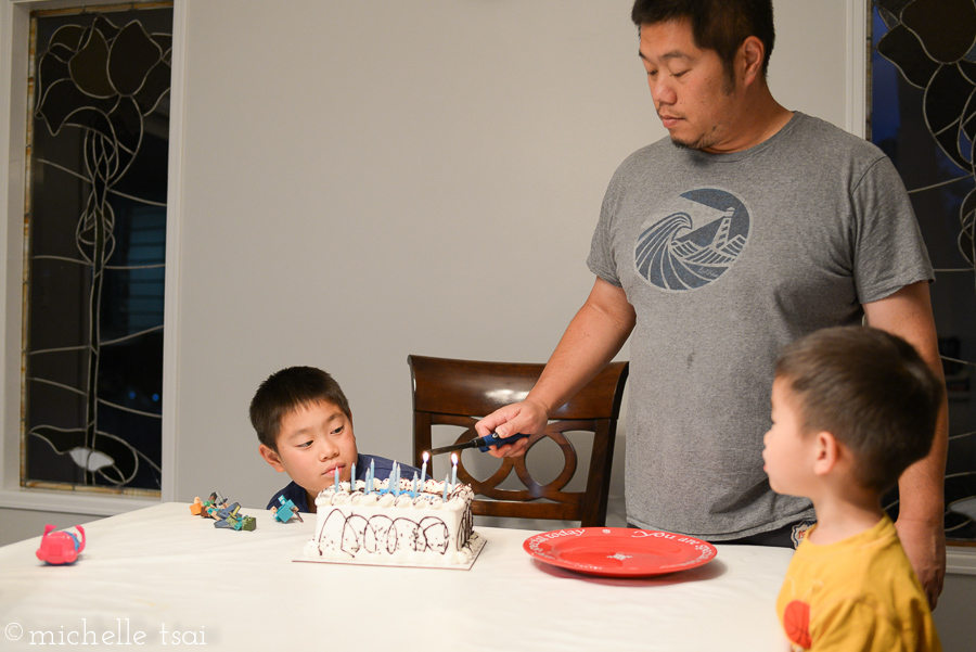 Watching the daddy light his eleven candles on his mint chip ice cream cake.