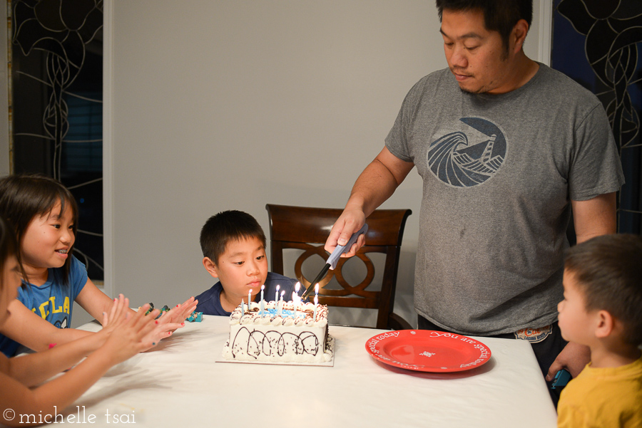 Warming their hands by the flame of the many candles.