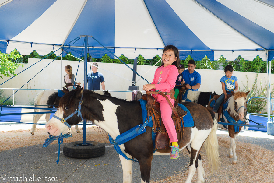 I spotted the pony ride tent on our way out but Phil dismissed it muttering about the expense of having all our kids go for a ride. Upon closer inspection, I discovered it was FREE given by our town chamber of commerce. 