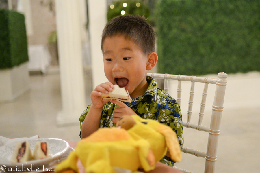 This is how this little gentleman eats his Nutella-strawberry tea sandwich.