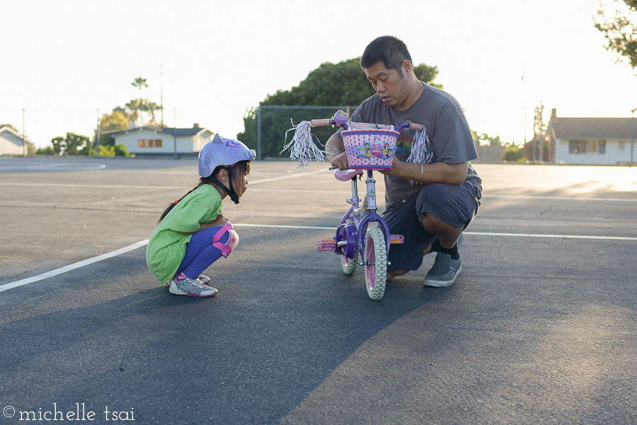 Her daddy decided she needed some adjustments made on her little bike.