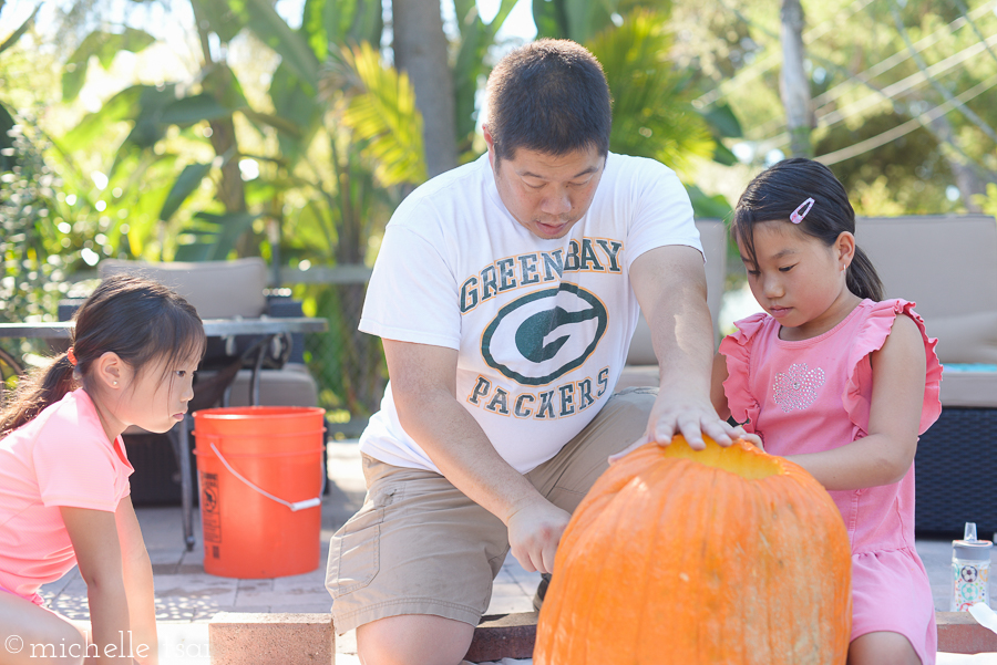 The girls needed some help cutting through the crazy thick pumpkin.