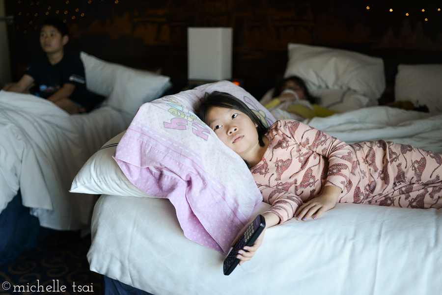 All snuggled in with their favorite pillow/blankie/stuffed animal watching cartoons together (probably Phinneas and Ferb).